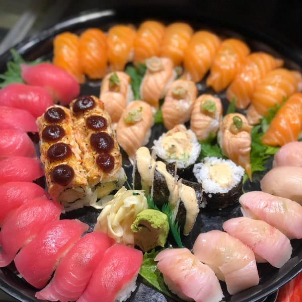 A large platter of Kameya Sushi's colorful sushi, including nigiri, rolls, and sashimi.
