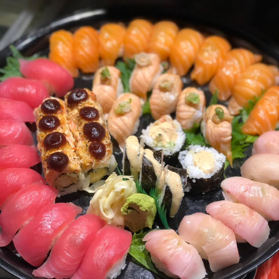 A large platter of Kameya Sushi's colorful sushi, including nigiri, rolls, and sashimi.